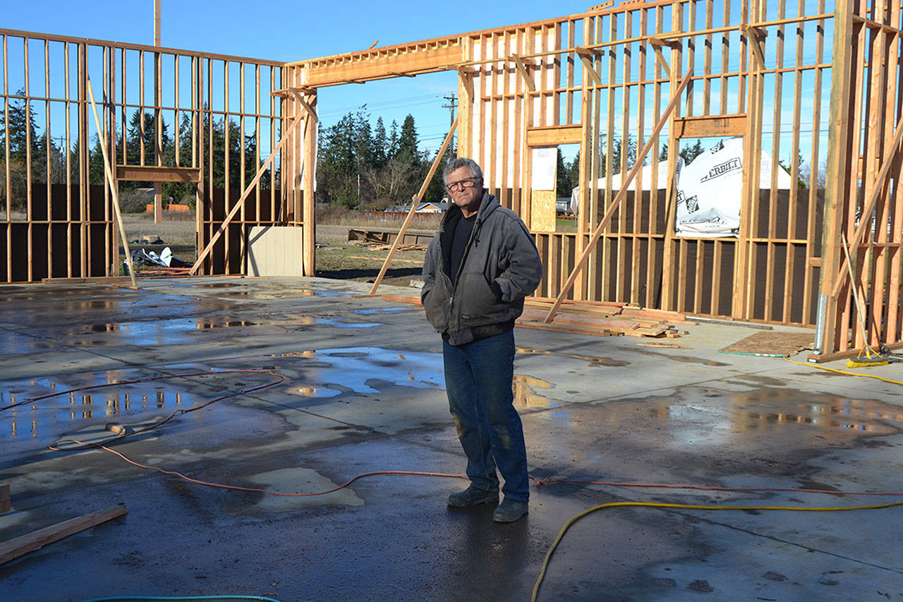Contractor Chris Grubb stands on the site of his planned shop. In mid-January, a wind storm blew down the trusses one day after he and his family installed 51 of them. Family members look to support him by running a Gofundme account to cover his losses. Sequim Gazette photo by Matthew Nash
