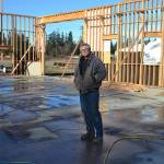 Contractor Chris Grubb stands on the site of his planned shop. In mid-January, a wind storm blew down the trusses one day after he and his family installed 51 of them. Family members look to support him by running a Gofundme account to cover his losses. Sequim Gazette photo by Matthew Nash