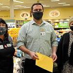 Sequim Safeway checker Colleen Tenneson and manager Joe Barton helped raised more than $87,000 from customer donations for the Sequim Food Bank fundraiser over November and December. Andra Smith, food bank executive director, on right, said donations will go towards gift cards, which she loves because it allows families to choose and make their own nutritional decisions. Sequim Gazette photo by Matthew Nash