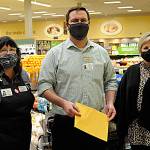 Sequim Safeway checker Colleen Tenneson and manager Joe Barton helped raised more than $87,000 from customer donations for the Sequim Food Bank fundraiser over November and December. Andra Smith, food bank executive director, on right, said donations will go towards gift cards, which she loves because it allows families to choose and make their own nutritional decisions. Sequim Gazette photo by Matthew Nash