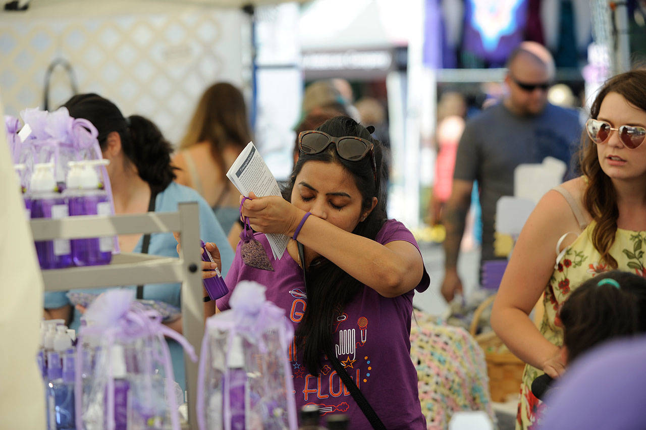 Rashi Jain of Seattle smells some lavender products in the Lets Do Lavender booth at the Lavender Festival Street Fair in July 2019. This summer will be the second consecutive time the novel coronavirus pandemic has led organizers to cancel the Street Fair in Carrie Blake Community Park. Sequim Gazette file photo by Matthew Nash
