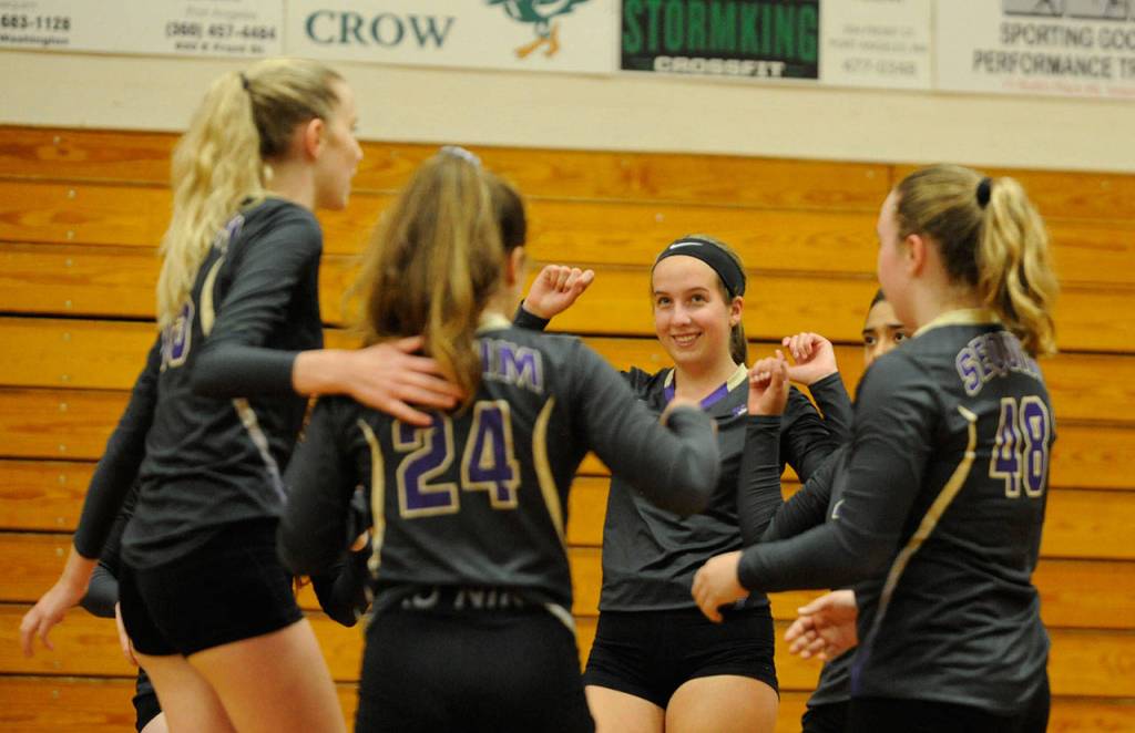 Sequim captain Kalli WIker (21) and teammates celebrate a point in the Wolves' three-game sweep of Port Townsend at the Wolves' season-opening jamboree in September 2019. Sequim Gazette file photo by Michael Dashiell