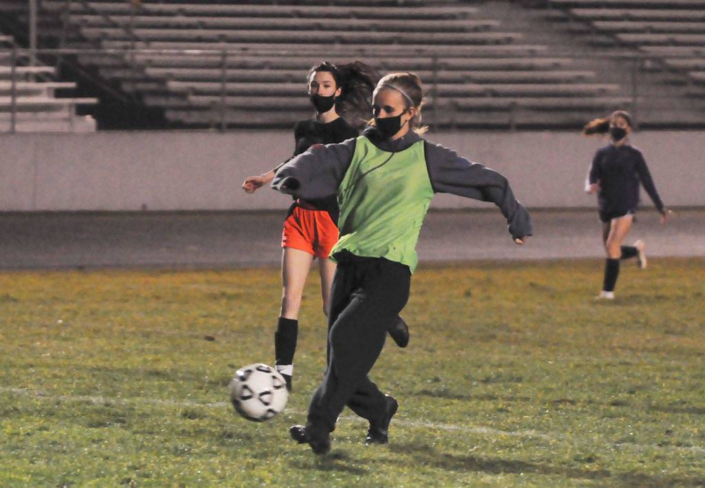 Sequims Hannah Wagner, foreground, looks to put a shot on goal at an early February practice. Sequim Gazette photo by Michael Dashiell