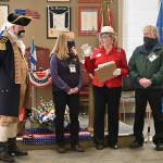 Kathy and Glenn Johnson (third from right, far right) of Mt. Pleasant I.G.S Store in Port Angeles accept an award from the Michael Trebert Chapter of the Daughters of the America Revolution on Feb. 17 in Port Angeles, at the groups annual George Washington Tea. Second from right, Carol Weiler  the chapters Recognition Tea Committee Chair  presents the Johnsons with the award, with Gen. George Washington (Vern Frykholm Jr.) looking on. Sequim Gazette photo by Michael Dashiell