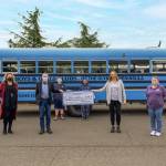 From left: Dollie Sparks, Windermere Sequim-East Director of Operations, and designated broker Alan Burwell (with, in background, youths Cole Tate and T.J. Rooke), present a donation to Janet Gray, Boys Girls Club Resource Development Director, and Sequim unit director Tessa Jackson. Submitted photo