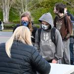 Sequim Middle School students  including Lucy and Ryan Spelker  line up on Tuesday, Feb. 16, to go back to class for in-person instruction, for the first time in about 11 months. SMS students will, like their cohorts at the Sequim elementary schools, be on an AA/BB hybrid schedule, with half of each grade back in classrooms on Mondays and Tuesdays, and the other half in class on Thursdays and Fridays. Sequim High School students are expected to return to in-person instruction on March 1. Sequim Gazette photo by Michael Dashiell