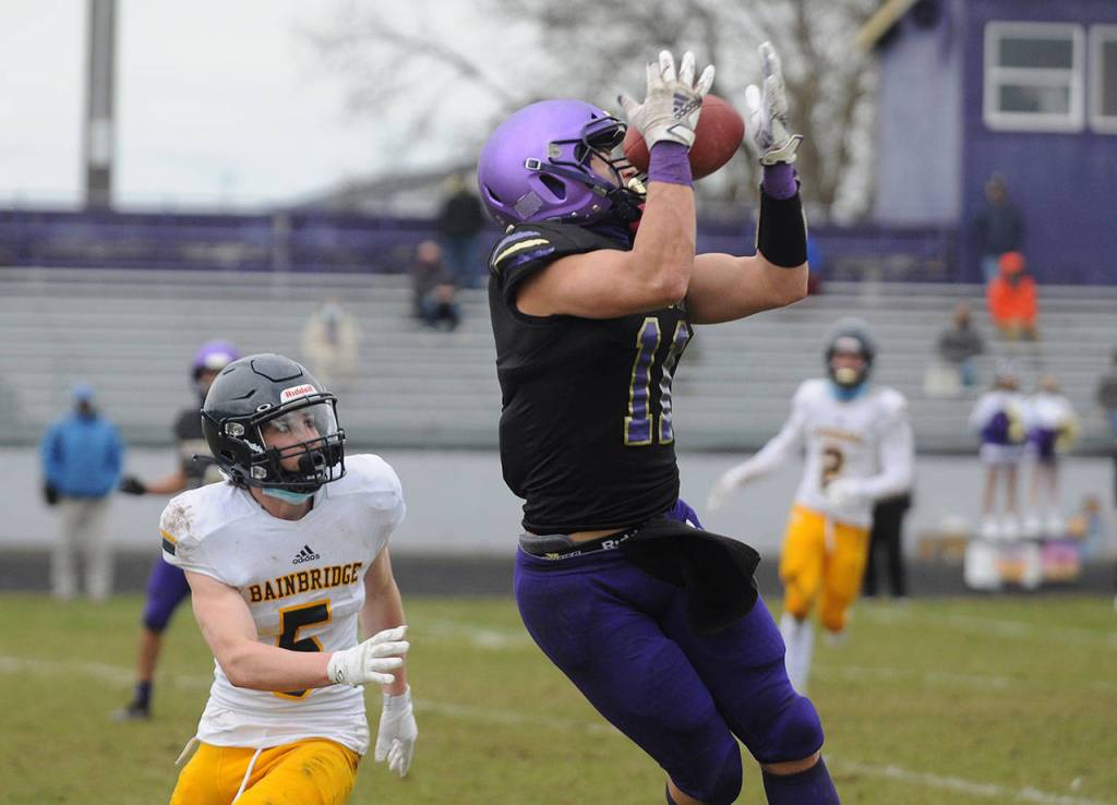 Sequim senior receiver Michael Young, right, hauls in a 34-yard pass from Kobe Applegate in the second half of Sequims shutout win over Bainbridge on Feb. 20. Sequim Gazette photo by Michael Dashiell