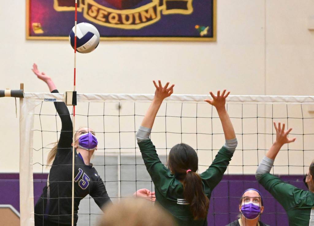 Sequims Kendall Hasting, left, looks for a big hit as teammate Kalli Wiker looks on, in a Feb. 25 home match against Port Angeles. Sequim Gazette photo by Michael Dashiell