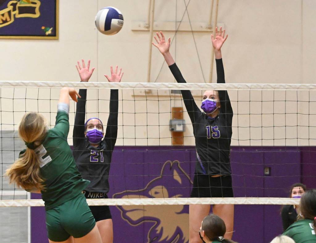 Sequims Kalli Wiker, left, and Kendall Hastings rise up to block a spike as the Wolves take on Port Angeles on Feb. 25. Sequim Gazette photo by Michael Dashiell