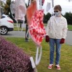 Kathy Tiedeman stands in front of the mask tree, or Giving Tree as some neighbors call it in front of Danette Bemis house. Since last April, she, Bemis and Krista Rambow have made more than 4,500 cloth masks to give to the community. Sequim Gazette photo by Matthew Nash