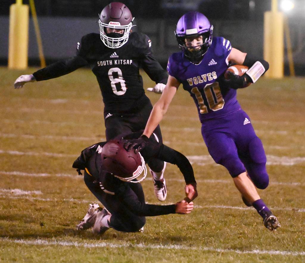 Sequim senior Garrett Hoesel, right, picks up 54 yards on a punt return in the first half of Sequims 27-15 home win over South Kitsap on March 5.