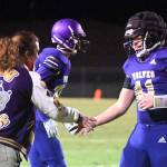 Sequim quarterback Lars Wiker, right, gets congratulations from older brother Taig after Lars tossed his first touchdown pass in the Wolves 27-15 win over South Kitsap on March 5. Sequim Gazette photo by Michael Dashiell