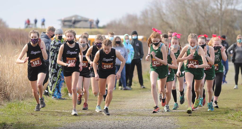 Sequim and Klahowya girls cross country teams break from the starting line at Voice of America Park in Sequim on March 6. Sequim edged the visiting Eagles by a point, 27-28 (low score wins). Sequim Gazette photo by Michael Dashiell