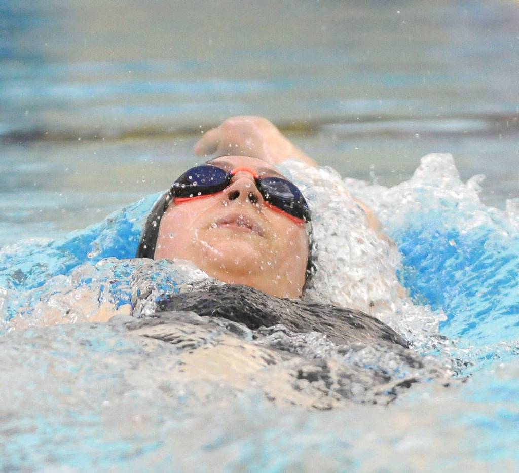 Sequims Sydnee Price competes in the 100 backstroke in the Wolves final regular season meet on March 5. Sequim Gazette photos by Michael Dashiell