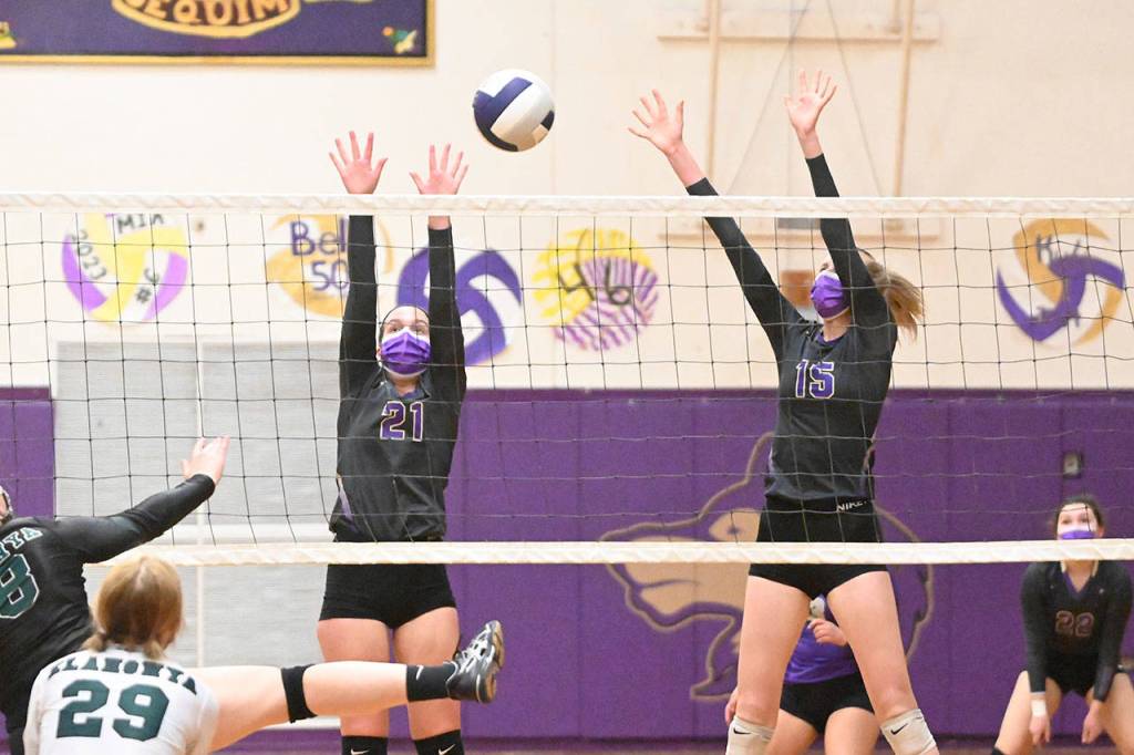 Sequims Kalli Wiker (21) and Kendall Hastings look for a block as the Wolves take on  and beat  Klahowya on March 8 at home. Sequim Gazette photo by Michael Dashiell