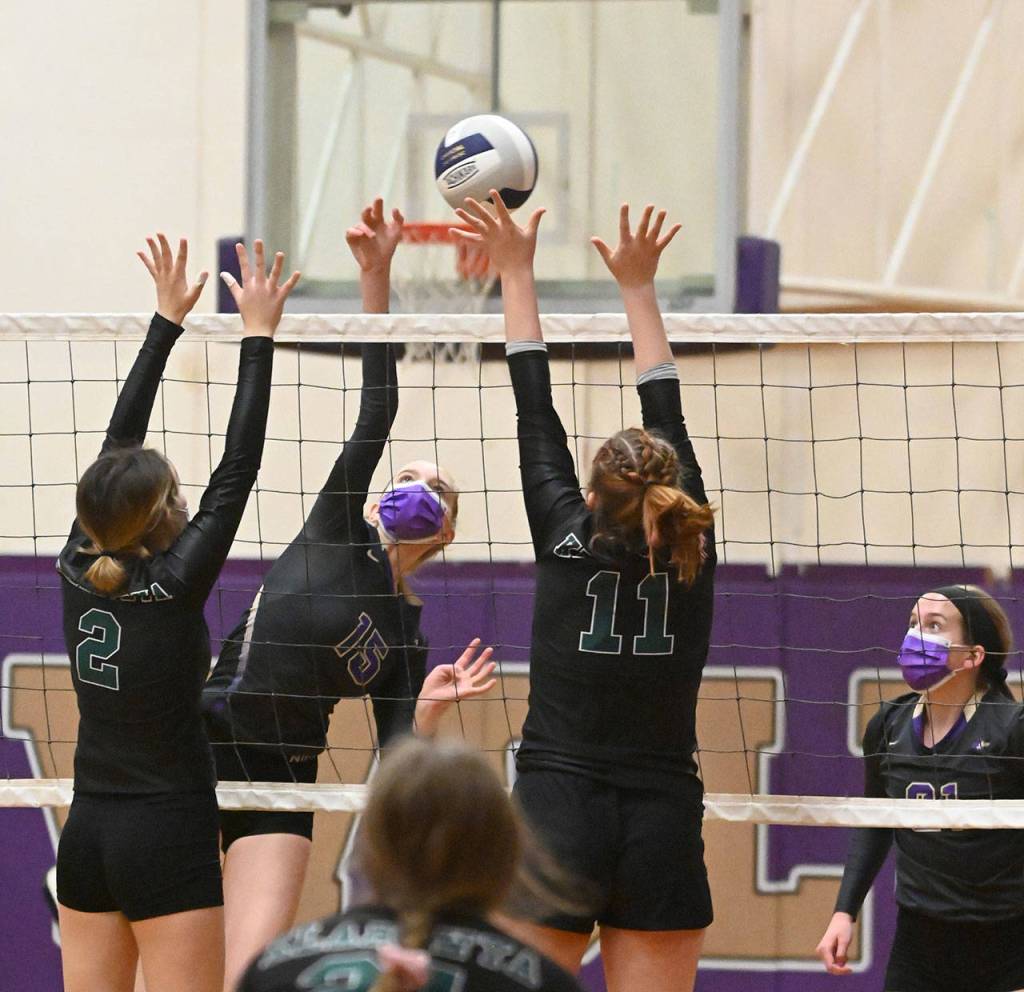 Sequims Kendall Hastings looks to hit past Klahowya defenders Alyssa Hintz (2) and Aleah Catt in the Wolves league win at home on March 8. Sequim Gazette photo by Michael Dashiell