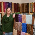 Nicole Driggs stands inside A Stitch in Time Quilt Shoppe, which opens this week on the 200 block of East Washington Street. Sequim Gazette photos by Michael Dashiell