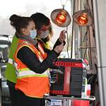 Registered nurses Kelly Bower and Dmitriy Lisenkoff prepare COVID-19 vaccination doses at the Jamestown Family Health Clinic drive-thru clinic in Sequim on March 4. Sequim Gazette photo by Michael Dashiell
