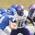 Braiden Kitchen looks to make a stop on Olympic running back Trent Feistner in the Wolves 21-12 loss at Olympic on March 13.