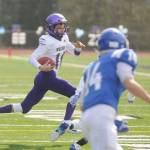 Sequim quarterback Kobe Applegate looks for a first down in the first half of Sequims loss at Olympic on March 13. Sequim Gazette photo by Michael Dashiell