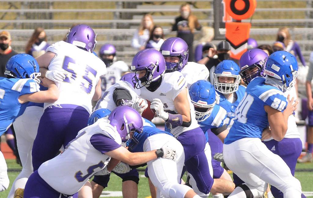 Sequim running back Walker Ward funds running room in the first half of Sequims 21-12 loss at Olympic on March 13. Sequim Gazette photo by Michael Dashiell