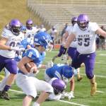 Sequims Faas Christianson, left, and Brandon Barnett try to track down Olympic running back Trent Feistner in the Wolves 21-12 loss at Olympic on March 13. Sequim Gazette photo by Michael Dashiell