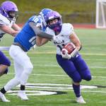 Sequims Michael Young tries to evade the grasp of Olympic safety Xavier Valenzuela in the Wolves 21-12 loss on March 13 at Olympic. Sequim Gazette photo by Michael Dashiell