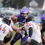 Sequim quarterback Taig Wiker looks for running room as he scrambles for a 6-yard touchdown in the first half of the Wolves 38-22 win over Central Kitsap on March 18. Wiker rushed for 130 yards and two scores, and threw for another 166 yards and a touchdown. Sequim Gazette photo by Michael Dashiell