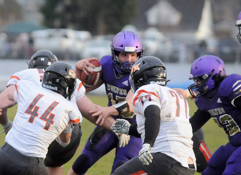 Sequim quarterback Taig Wiker looks for running room as he scrambles for a 6-yard touchdown in the first half of the Wolves 38-22 win over Central Kitsap on March 18. Wiker rushed for 130 yards and two scores, and threw for another 166 yards and a touchdown. Sequim Gazette photo by Michael Dashiell