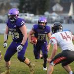 Sequim quarterback Taig Wiker gets some key blocking from Brandon Barnett (55) in the first half of Sequims season finale against Central Kitsap on March 18. Sequim Gazette photo by Michael Dashiell