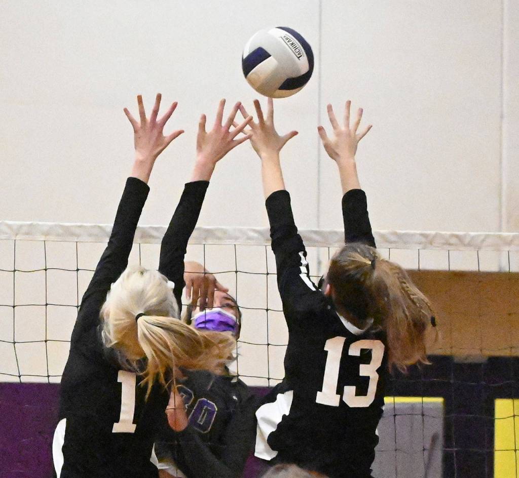 Sequim senior Jayla Julmist hits past Central Kitsaps Baylee Anderson (1) and Becca Roy in the Wolves four-set win over the visiting Cougars on March 20. Sequim Gazette photo by Michael Dashiell