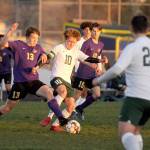 Sequims Brandon Charters, left, and Port Angeles Damon Gunderson vie for possession in a March 25 match in Sequim. The host Wolves shut out their cross-peninsula rivals, 2-0. Looking on are Sequims Eli Gish (13) and Port Angeles Dominick Fischer (22). Sequim Gazette photo by Michael Dashiell