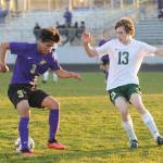 Sequims Cristian Gonzalez, left, looks to make a move past Port Angeles Josiah Long in the Wolves 2-0 home-opener win over the Roughriders on March 25. Sequim Gazette photo by Michael Dashiell