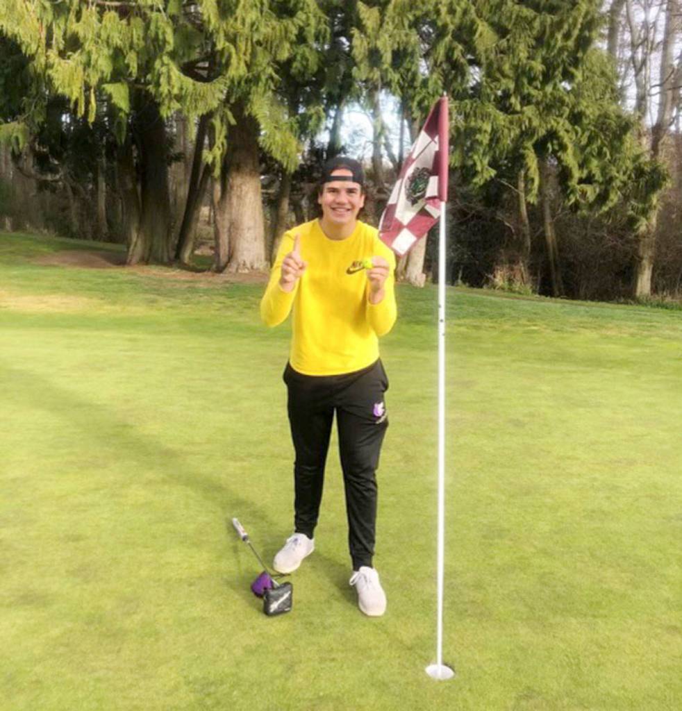 Sequims Pryce Glasser celebrates a hole-in-one at a preseason practice at The Cedars at Dungeness. Submitted photo