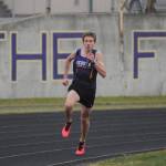 Sequim freshman Colby Ellefson anchors the Wolves 4x400 relay team as they host Olympic on March 24. Sequim Gazette photo by Michael Dashiell