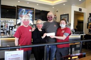 Tedescos and Sequims Welfare for Animals Guilds (WAG) partnered again with a portion of one nights sales helping local dogs. Christina and Eric Thompson, Tedescos co-owners, in middle, gave the donation to Barbara Brabant, WAGs board president, on left, and ranch manager Mel Marshall, right. Sequim Gazette photo by Matthew Nash