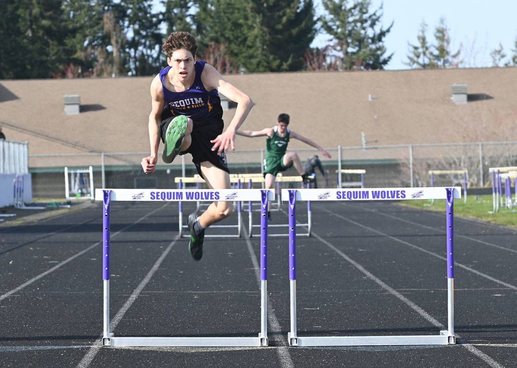 Sequims Adrian Brown races to a first place finish in the 300 meter hurdles on March 31. He finished in 47.86 seconds. Sequim Gazette photo by Michael Dashiell
