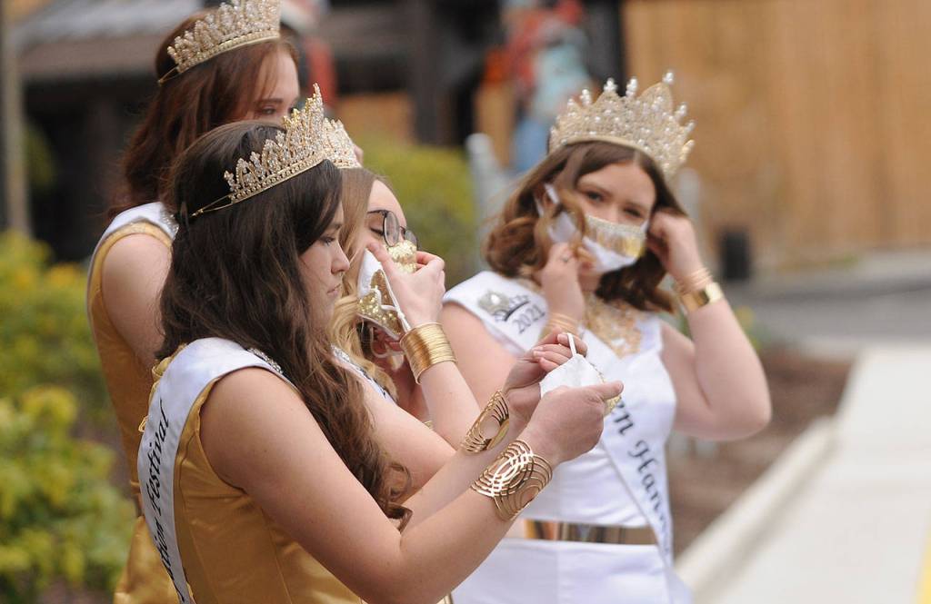 Sequim Irrigation Festival royalty don facemasks prior to the float reveal event on April 3.