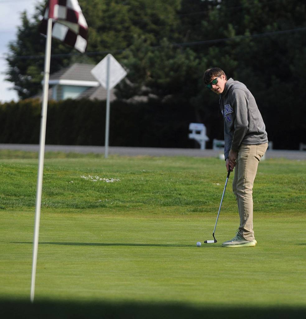 Sequims Kaleb Needoba putts at the first hole at The Cedars at Dungeness on April 8. Sequim Gazette photo by Michael Dashiell