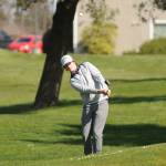 Sequims Ben Sweet hits an approach shot on the first hole at The Cedars at Dungeness on April 8.