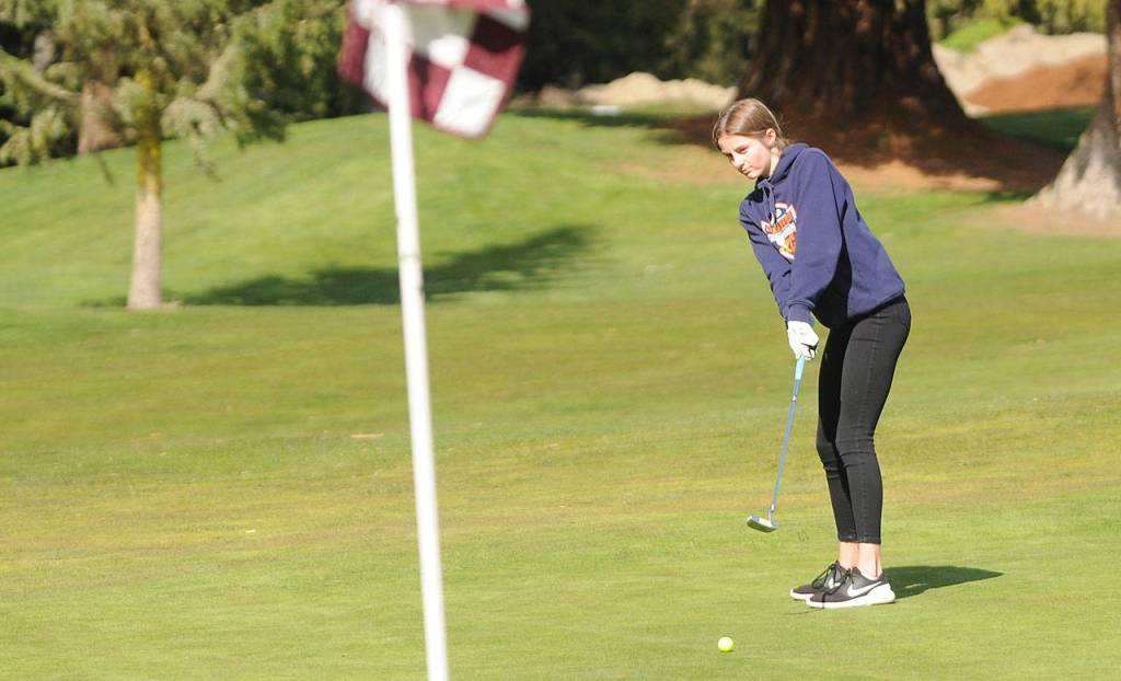 Sequims Sara German lines up a putt on the first hole at The Cedars at Dungeness on April 8. Sequim Gazette photo by Michael Dashiell