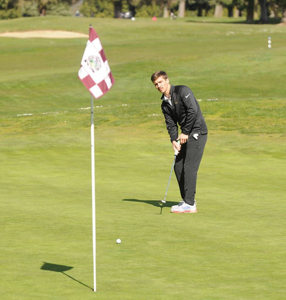 Sequims Garrett Hoesel lines up a putt on the first hole at The Cedars at Dungeness on April 8. Sequim Gazette photo by Michael Dashiell
