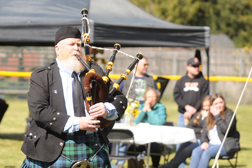 The Parking Lot Piper (Eric Evans) plays Amazing Grace at the memorial and fundraiser honoring Don Knapp at James Standard Memorial Park on April 11. Sequim Gazette photo by Michael Dashiell