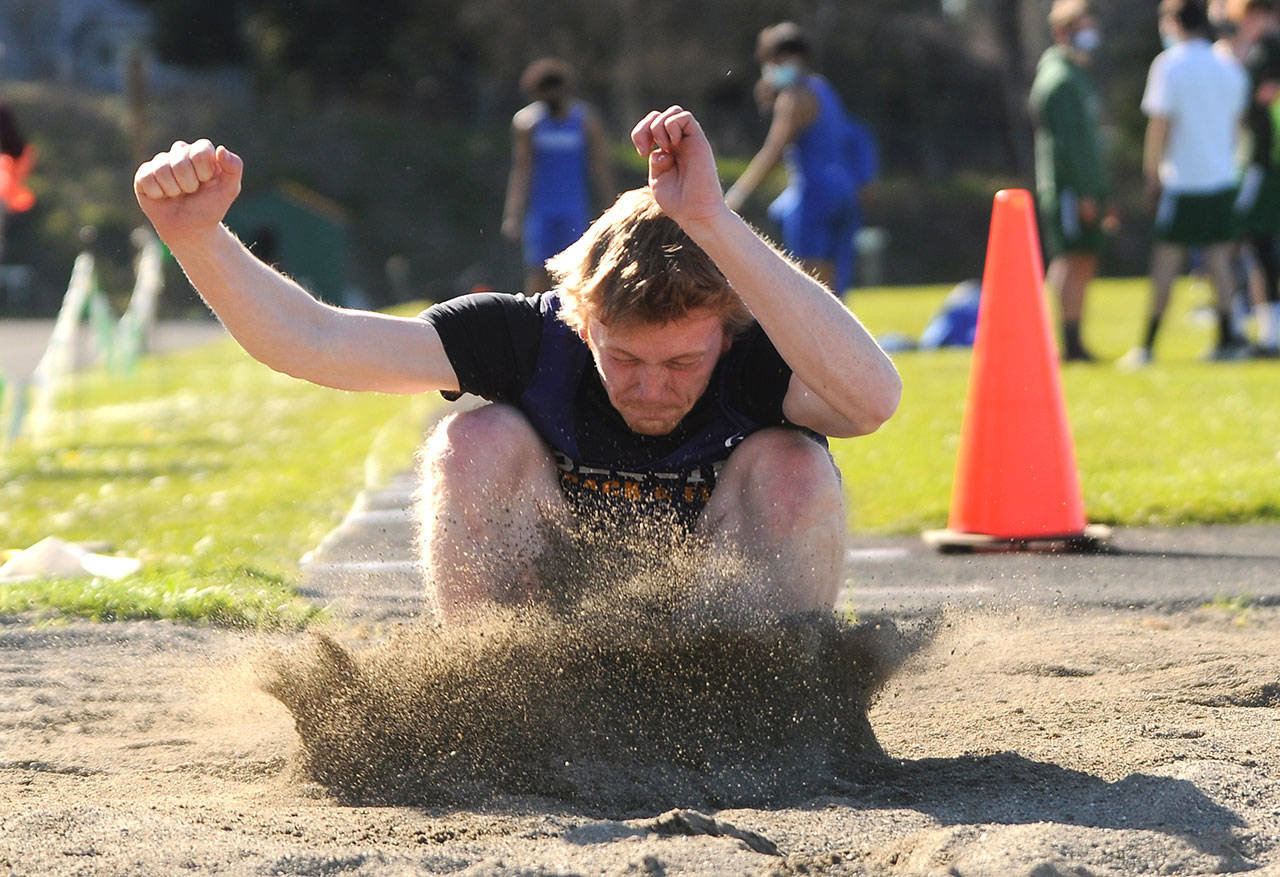 Sequims Logan Laxson leaps to a personal-best 20 feet in the long jump to take first place in a four-team meet in Port Angeles on April 14. Sequim Gazette photos by Michael Dashiell