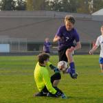 Sequims Solas McGruther, a freshman, puts the finishing touch on the Wolves 6-1 home win over Olympic on April 19, leaping past the Trojan keeper for a score in the 75th minute. Sequim Gazette photo by Michael Dashiell