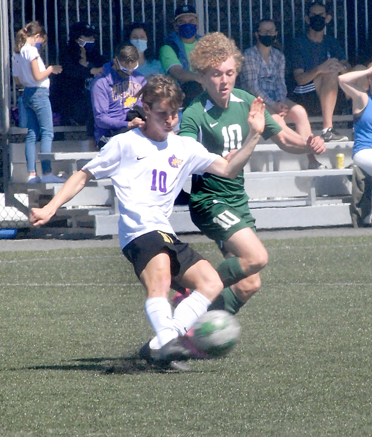Sequims Eli Gish, left, and Port Angeles Damon Gundersen compete for control at midfield at Peninsula College on April 17. Photo by Keith Thorpe/Olympic Peninsula News Group