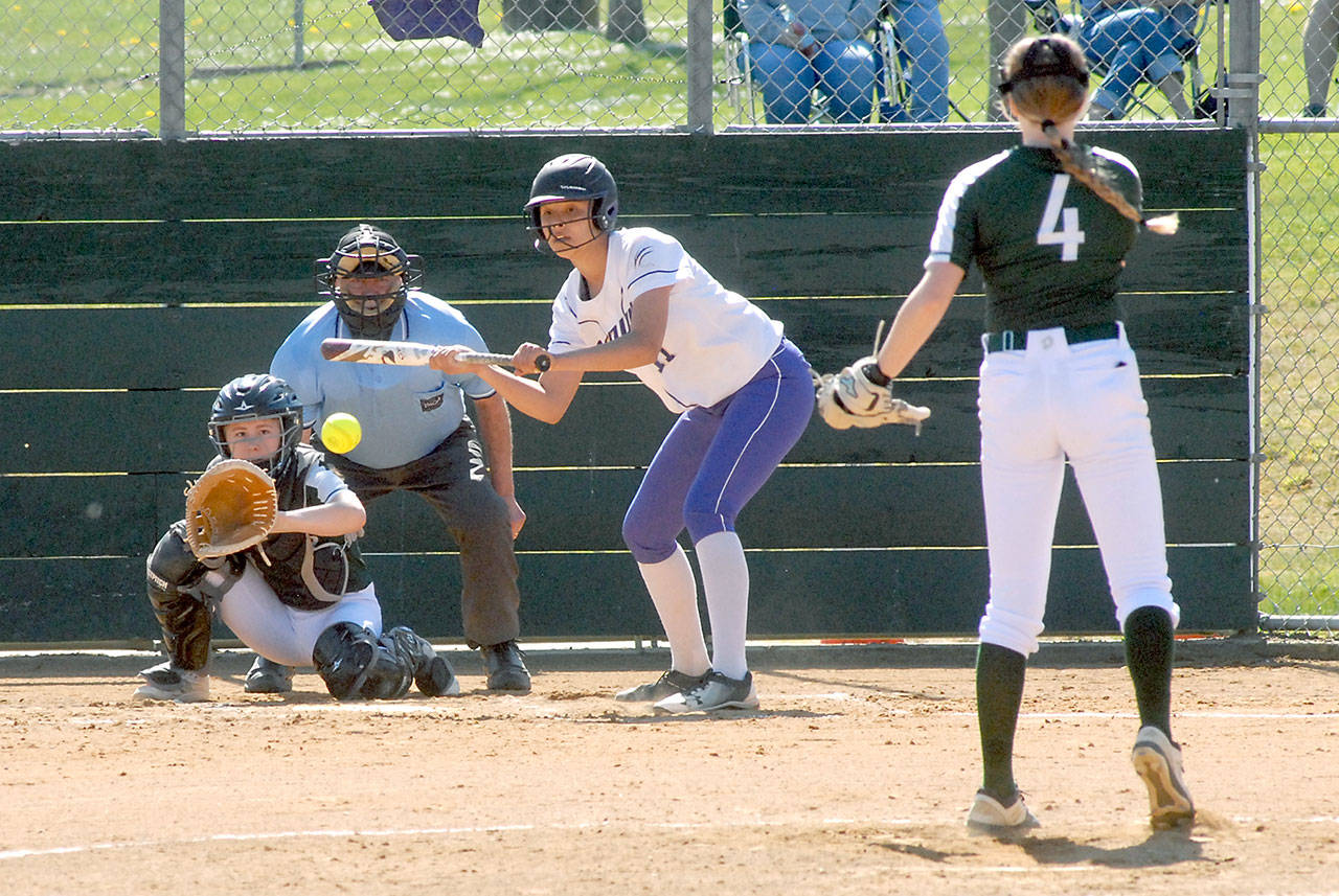 Sequims Kiana Robideau attempts to bunt against the pitch from Port Angeles Teagan Clark while catcher Zoe Smithson waits for the delivery during the second inning at the Dry Creek Athletic Fields in Port Angeles on April 17. Photo by Keith Thorpe/Olympic Peninsula News Group