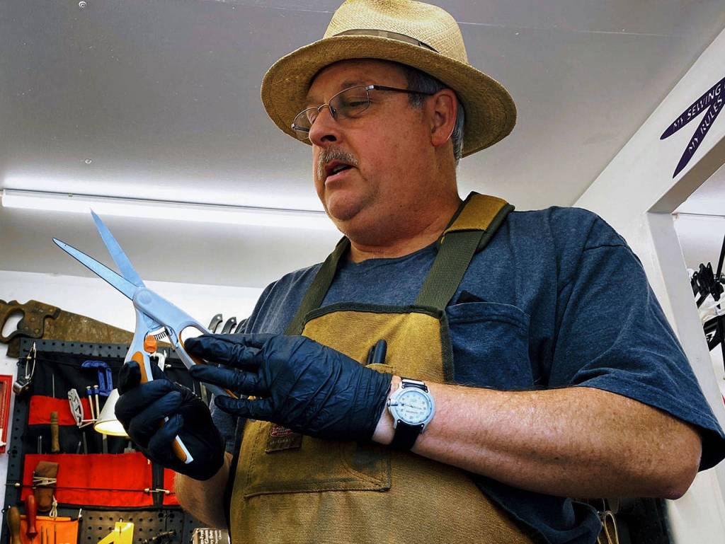 Dennis Westendorf of A Razor Edge Precision Sharpening takes a look at a pair of snips in need of sharpening. Westendorf joins other vendors at the Sequim Farmers & Artisans Market, which opens Saturday, May 1. Photo by Emma Jane Garcia