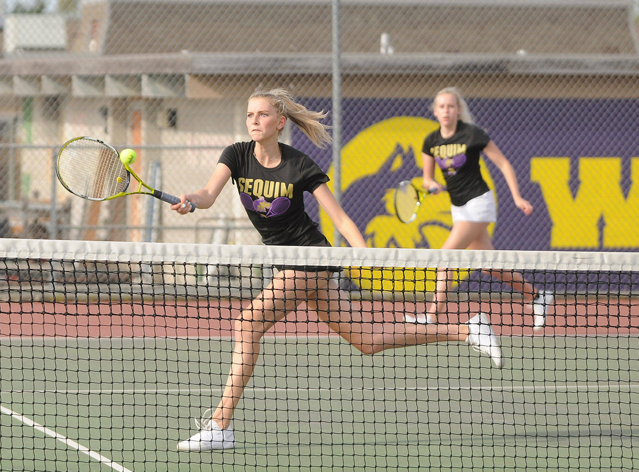 Sequims Kendall Hastings, foreground, puts away a point as sister McKenna backs her up in the Wolves 7-0 sweep of Bremerton on April 21. The Hastings duo topped Bremertons Jocelyn and Patricia Reyes, 6-1 and 6-0. Sequim Gazette photos by Michael Dashiell