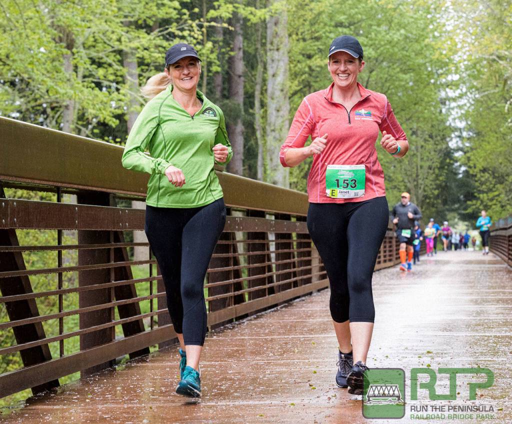 Jennifer Denton of Olympia, left, and Janet Parker of Port Angeles cross the historic Railroad Bridge in Sequim at the Run the Peninsula Railroad Bridge 5k/10k this past weekend. Photo by Port Angeles Marathon Association